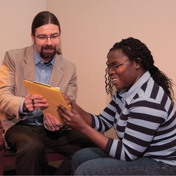 Walsh Student advisor is showing a file and talking to student